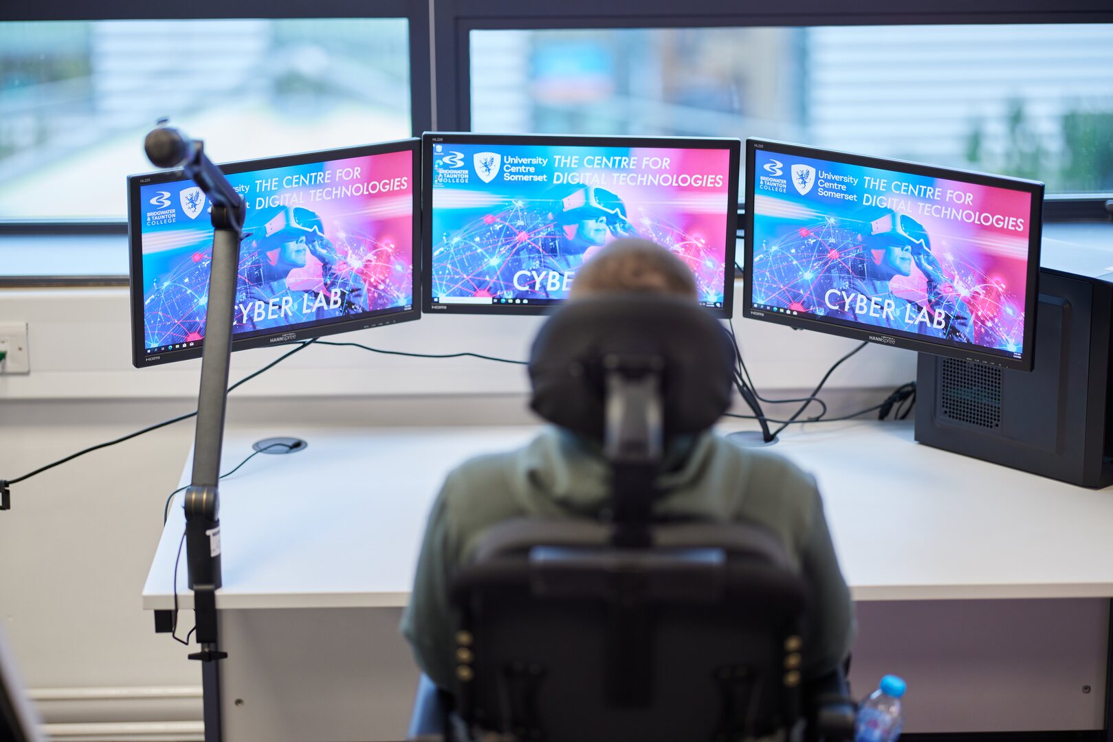 Centre for Digital Technologies, three screens, back of male student's head