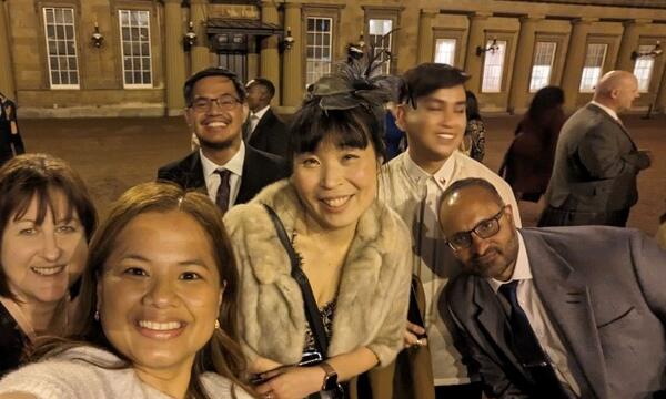 Sun and other reception attendees pictured outside Buckingham Palace